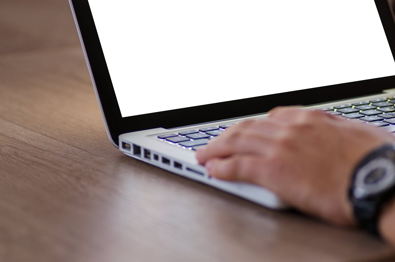 Crafting Captivating Headlines: Your awesome post title goes here Close-up of a hand using a laptop with a blank screen, ideal for adding custom content.